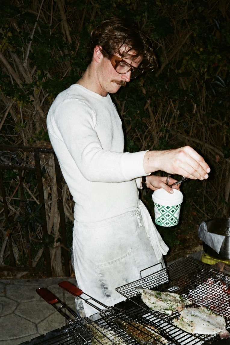 Zack grilling fish over live fire at a Motxo event