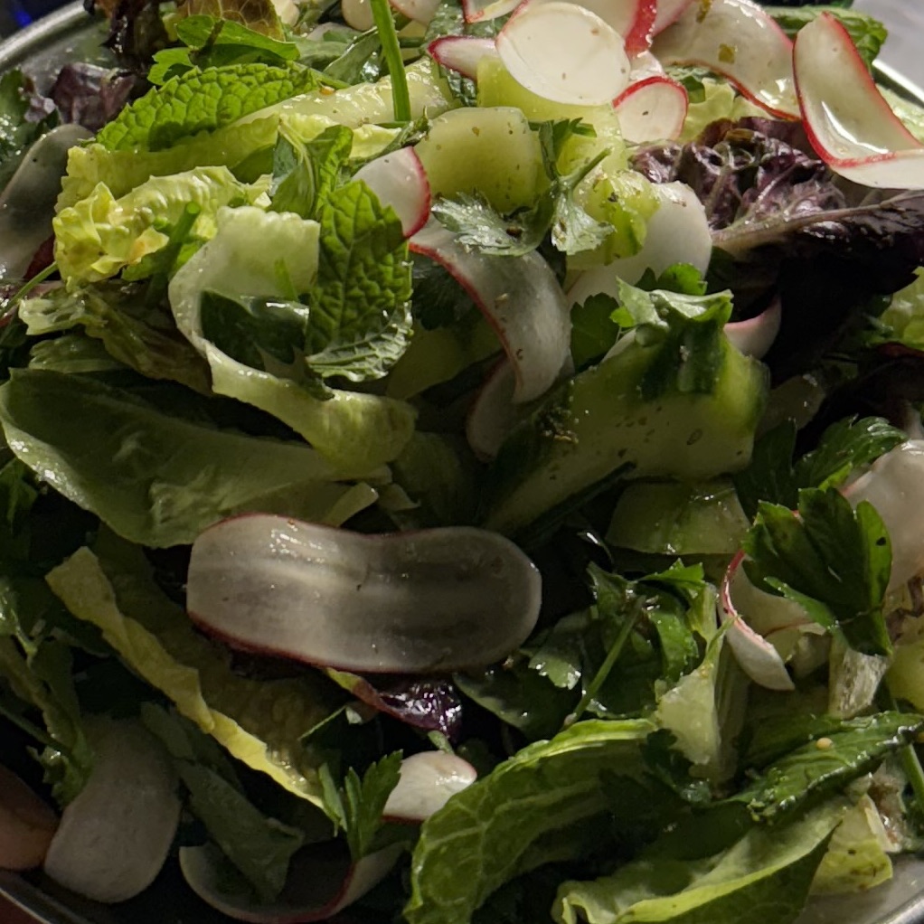 Dressed green salad and radishes